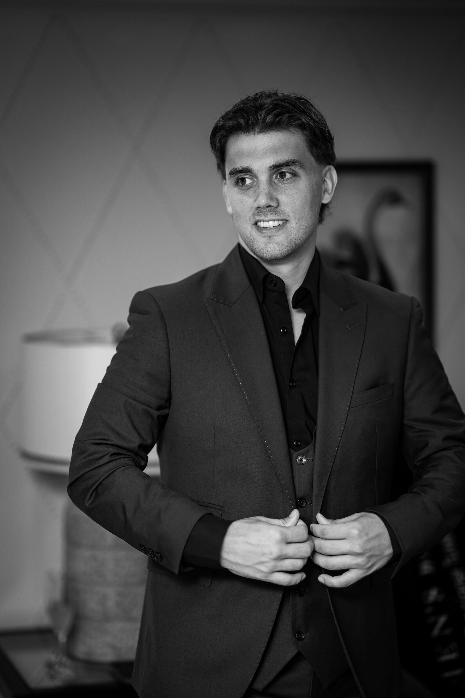 Black and white portrait of the groom in a three piece suit at Garvan Woodland Gardens, Hot Springs, Arkansas
