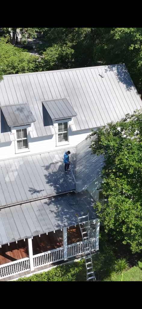 Professional roof washing service on a Charleston SC home