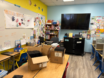 Boxes of laptops being unpacked at the School on Wheels learning center