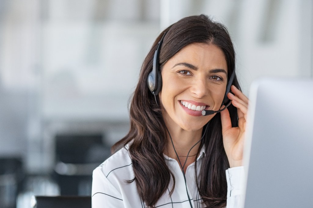 Patient smiling on phone with scheduling agent