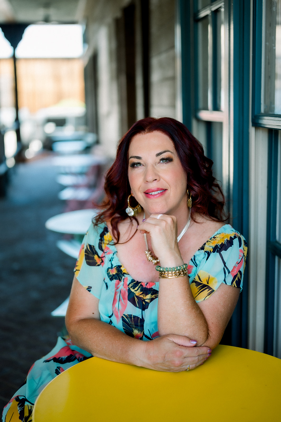 Businesswoman on location at a bright yellow table during a content branding session