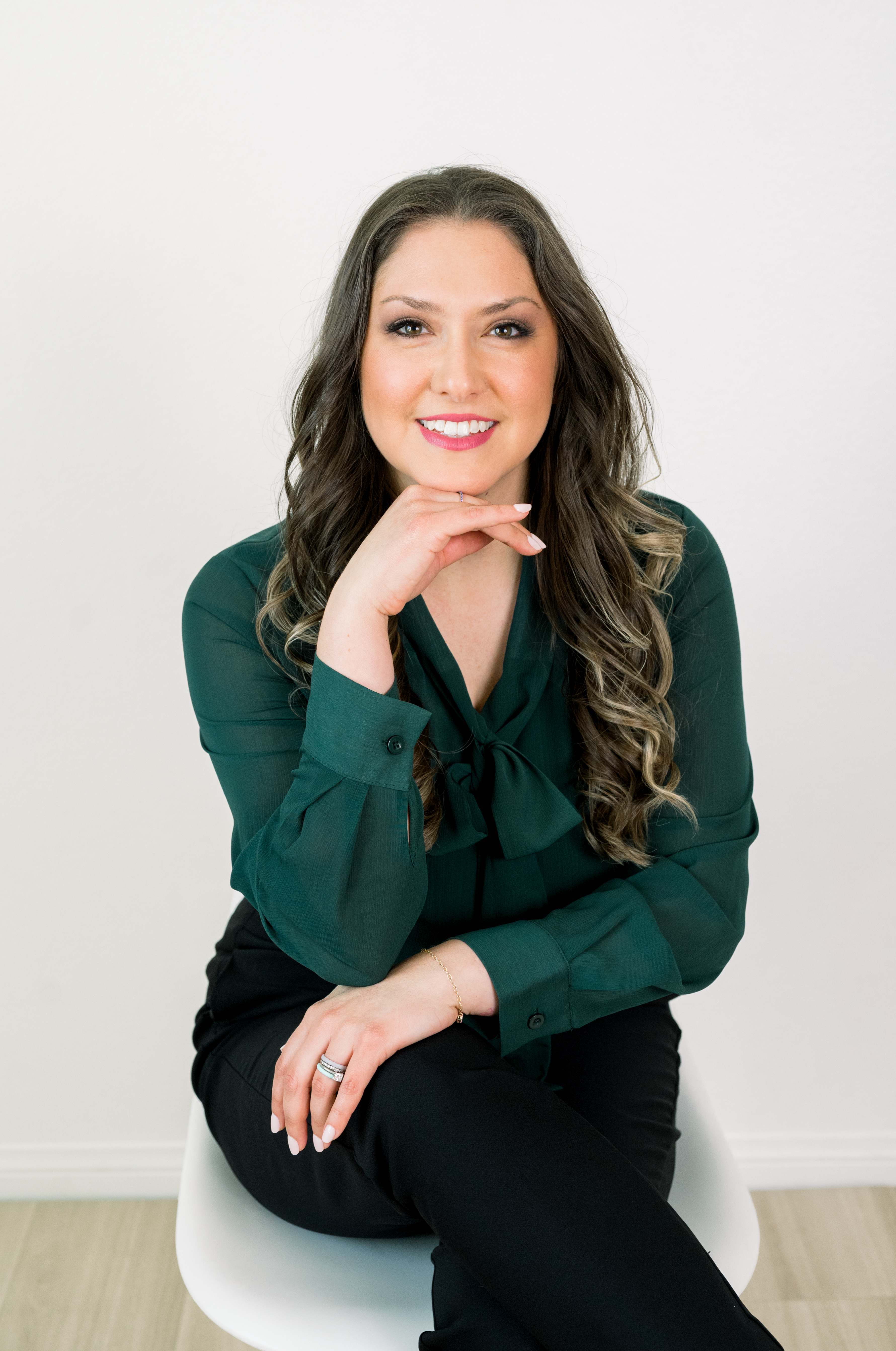Studio brand portrait of a client seated on a white chair