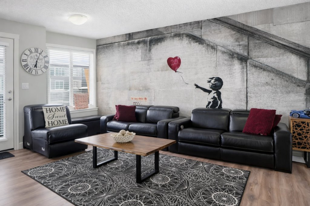 Banksy-inspired wall mural in a real estate living room in Calgary