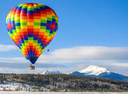 Colorful balloon over snowy mountains