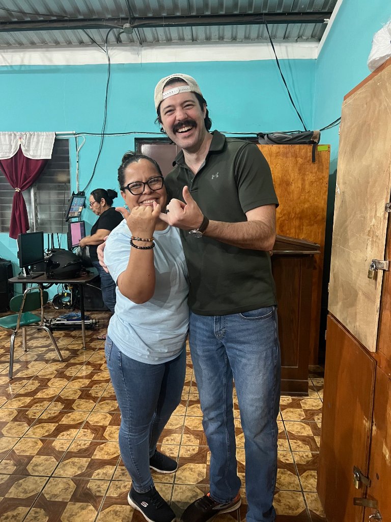 Team member with local patient after fitting glasses