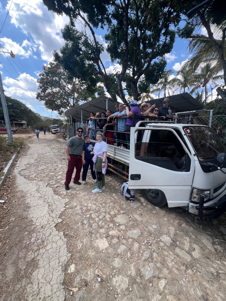 Team gathered around transport truck