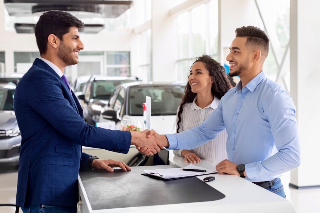Drive Select Finance broker finalising a car loan with customers at a dealership
