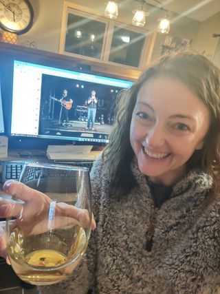 Attendee with wine at Happy Hour
