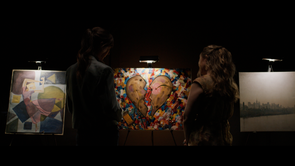 Palette of Dreams still of two characters viewing paintings in a gallery