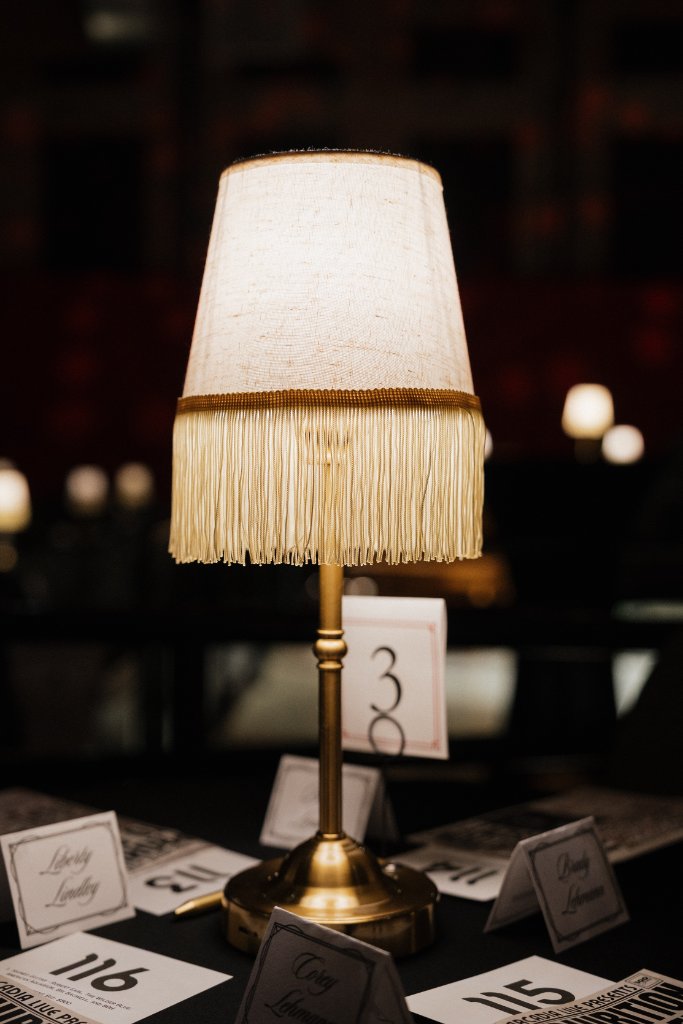 Jazz-era upright piano with fringe lampshades