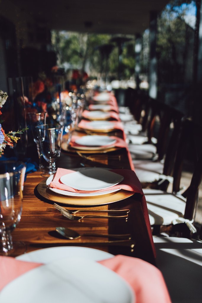 Luxury picnic setup with elegant floral arrangements and golden hour lighting