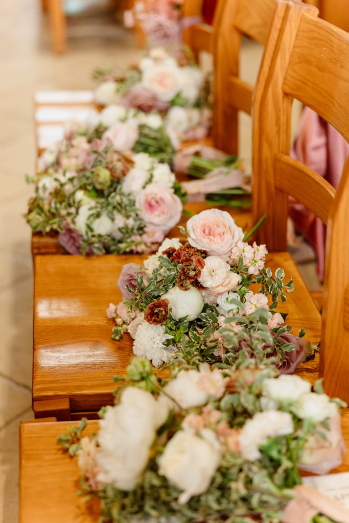 Blush baptism decor with floral arches and custom name sign