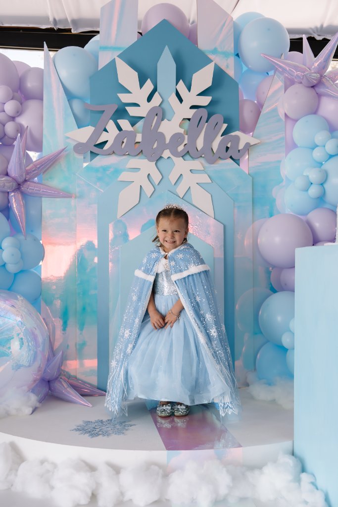 Frozen themed birthday party with balloon arch and character cutouts