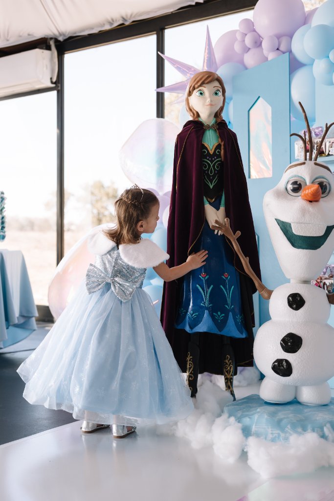 Little girl in Frozen costume at decorated event