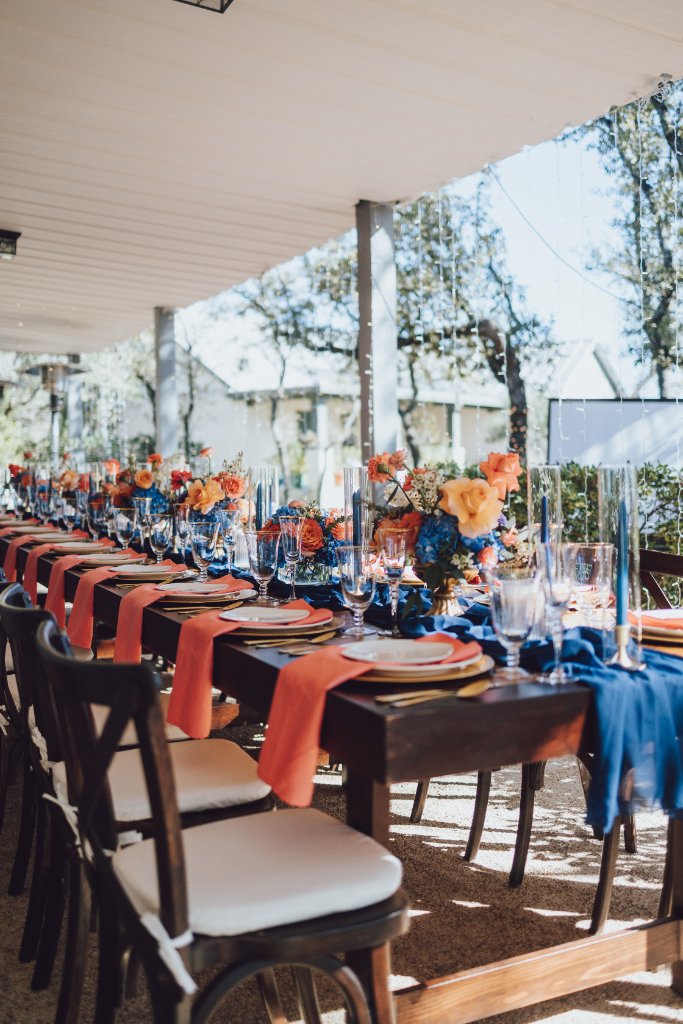Elegant navy and coral outdoor wedding tablescape