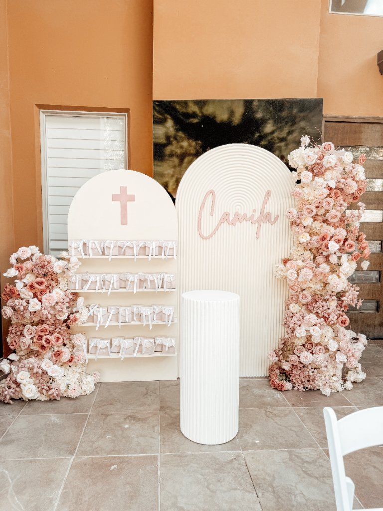 Wedding first kiss with floral ceremony arch