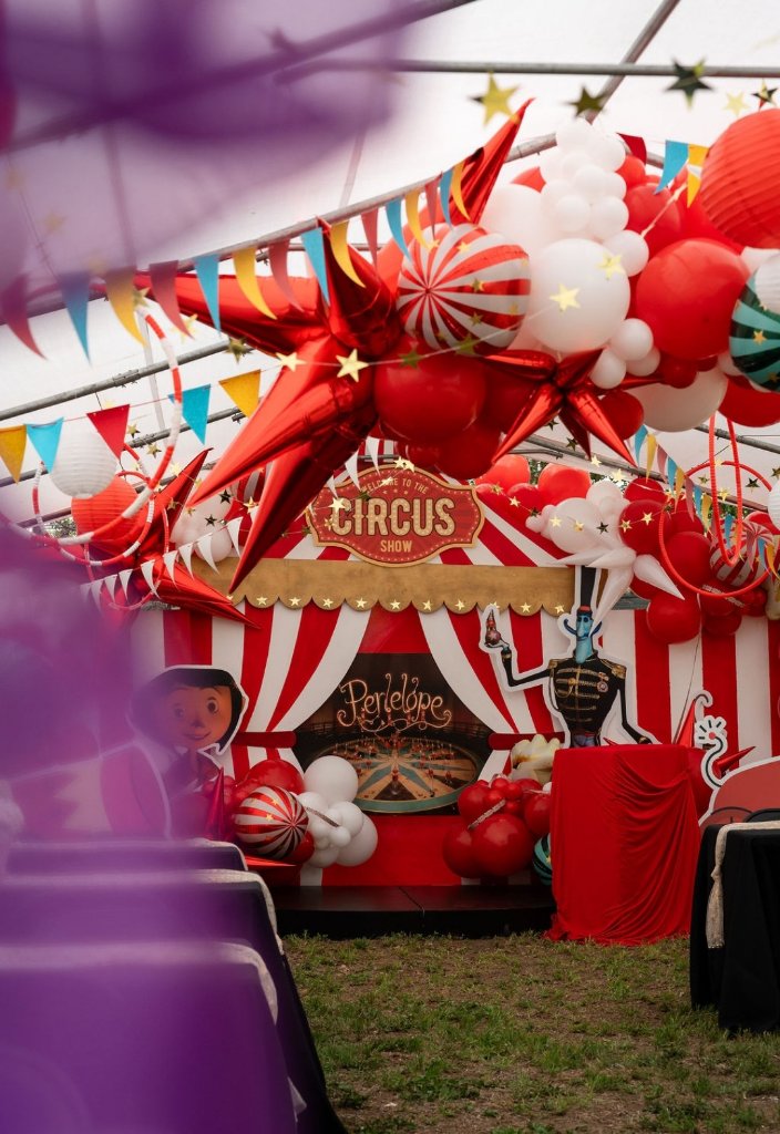 Circus themed balloon installation with colorful pennant flags
