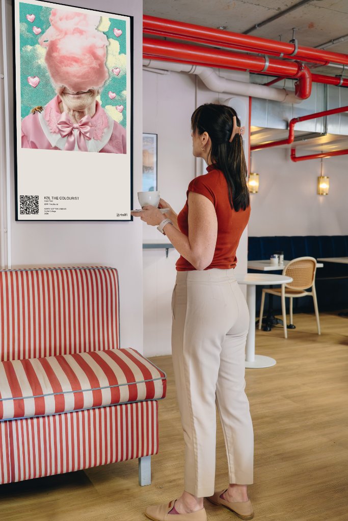 Person viewing art on a digital canvas in a café space