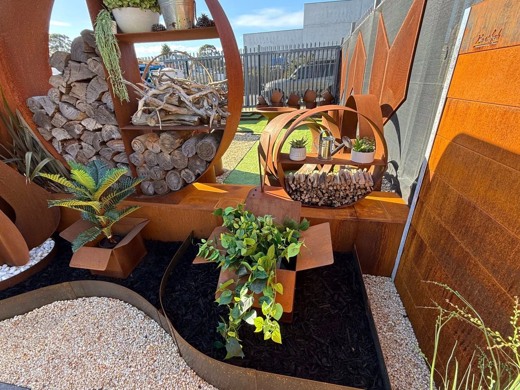 Rustfab garden display with wood stacker