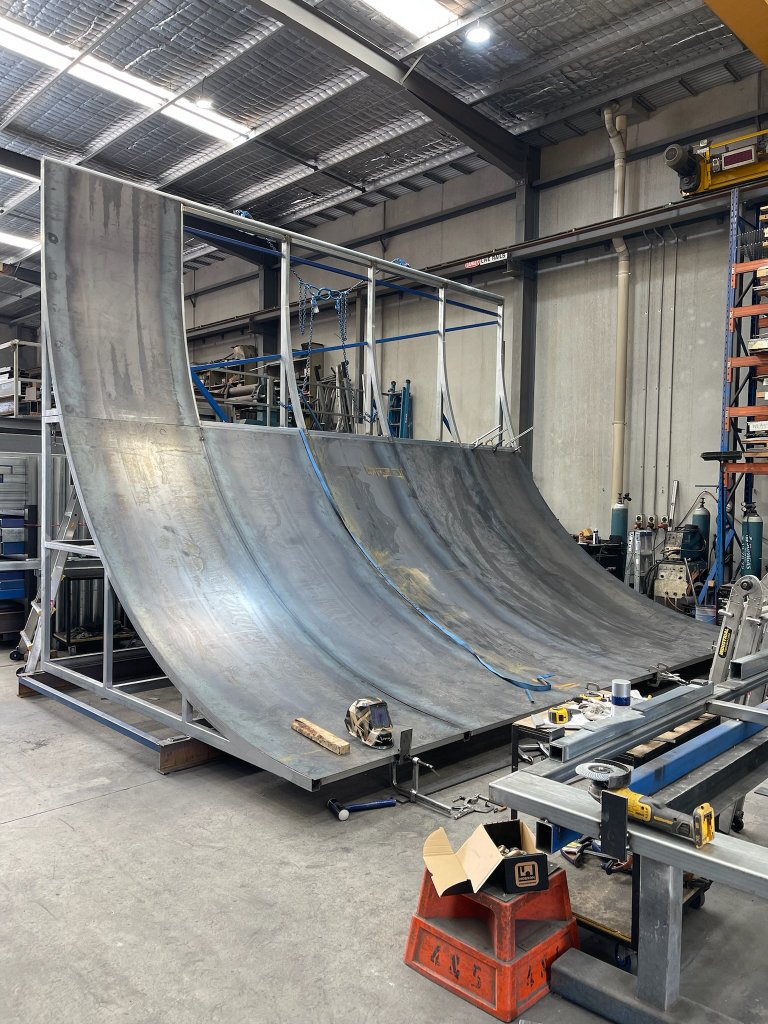 Curved steel ramp structure fabrication in workshop