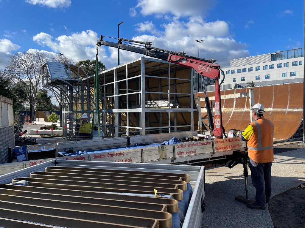 Steel ramp frame fabrication with Fassi crane truck on site