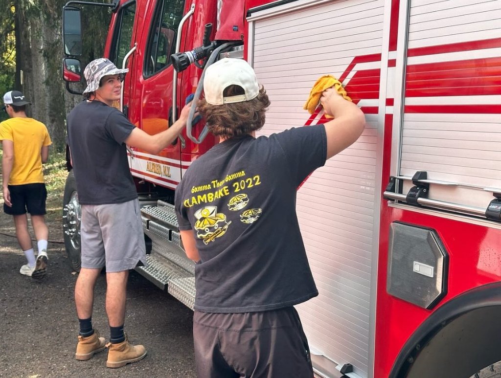 Community Service — washing fire trucks for Alfred Fire Dept.