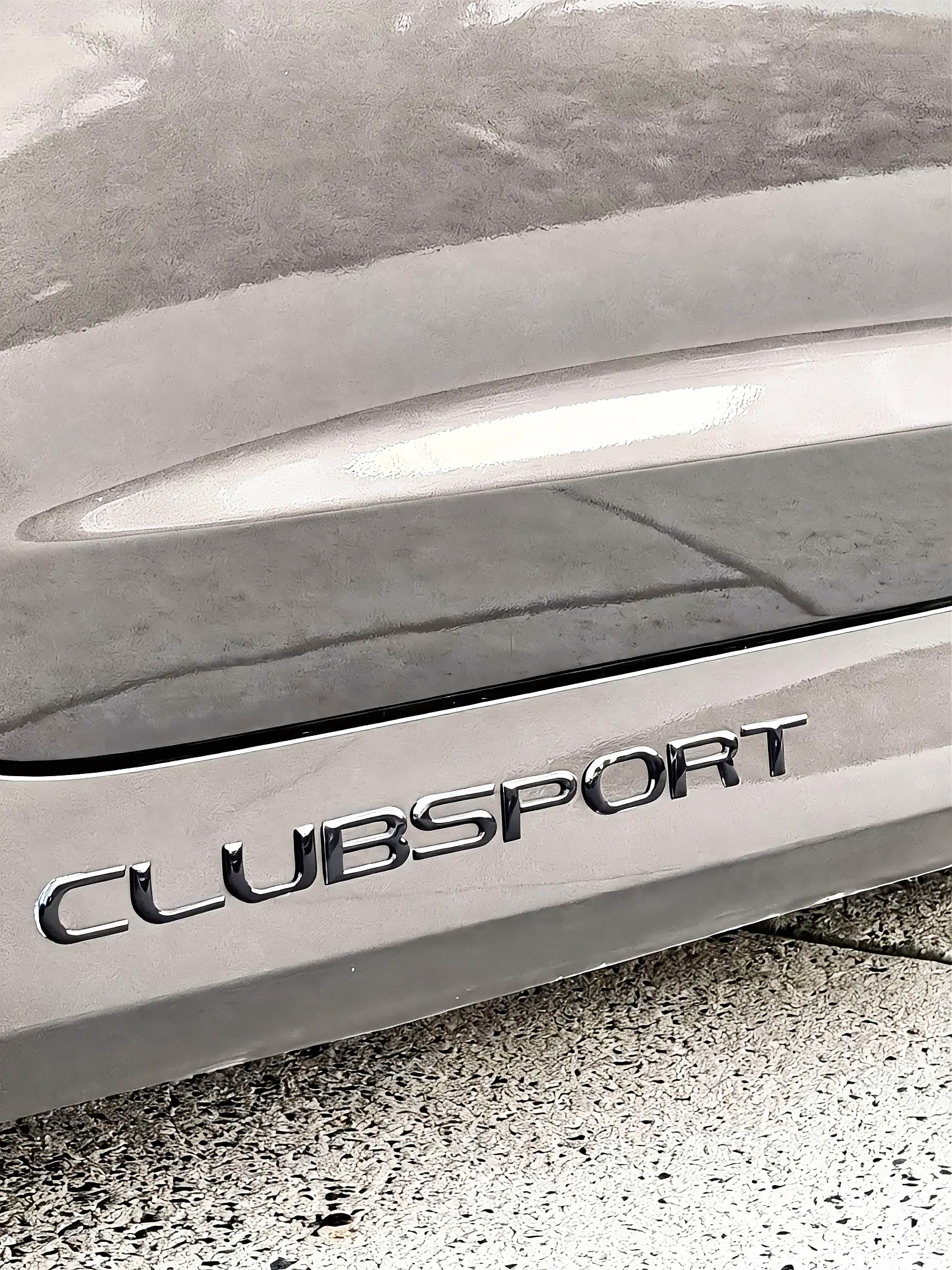 Clubsport lettering over the corrected rocker panel.