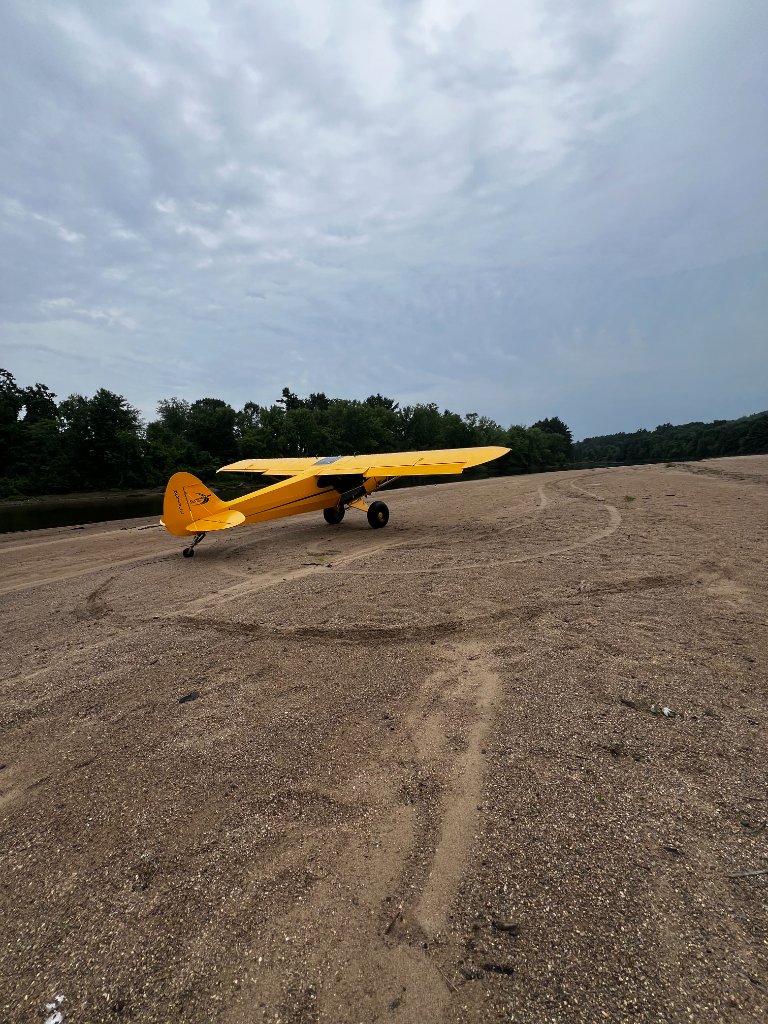 Tailwheel aircraft on riverbank