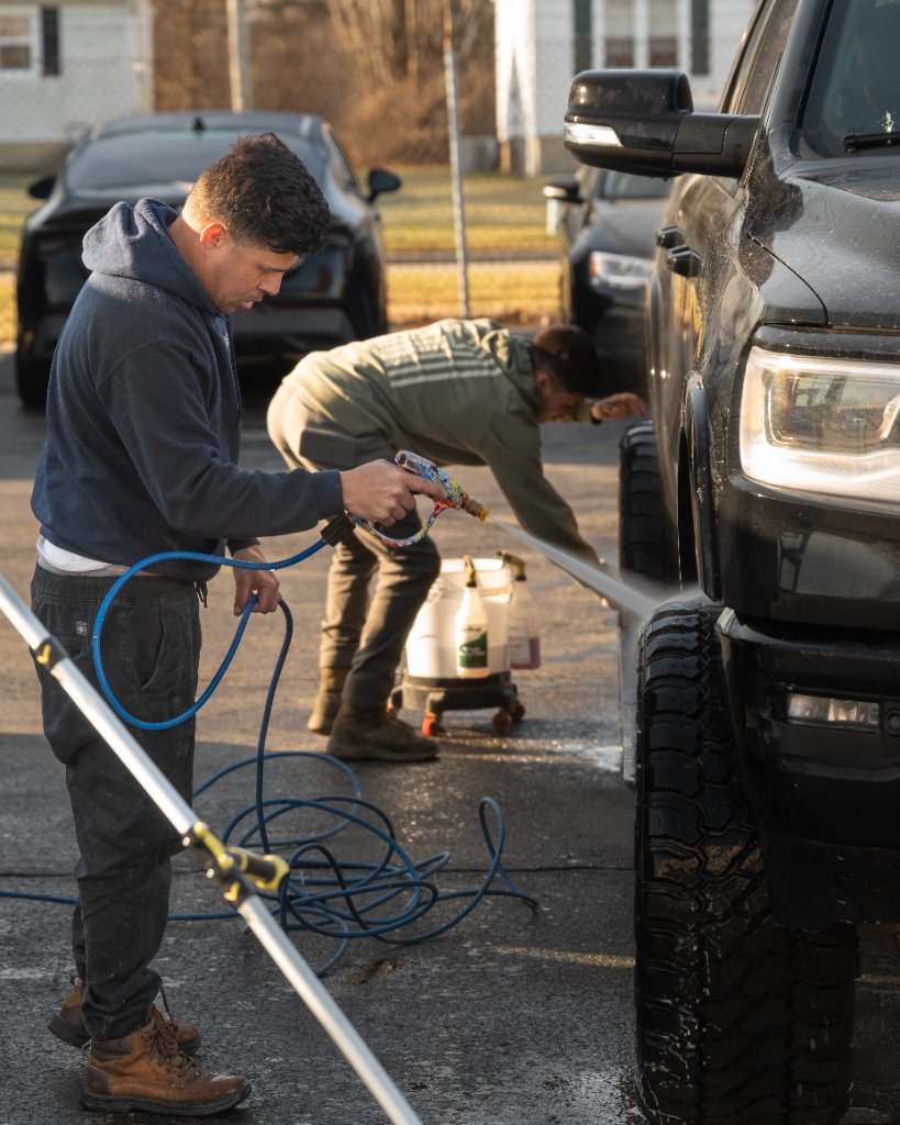 Two techs detailing a truck on location