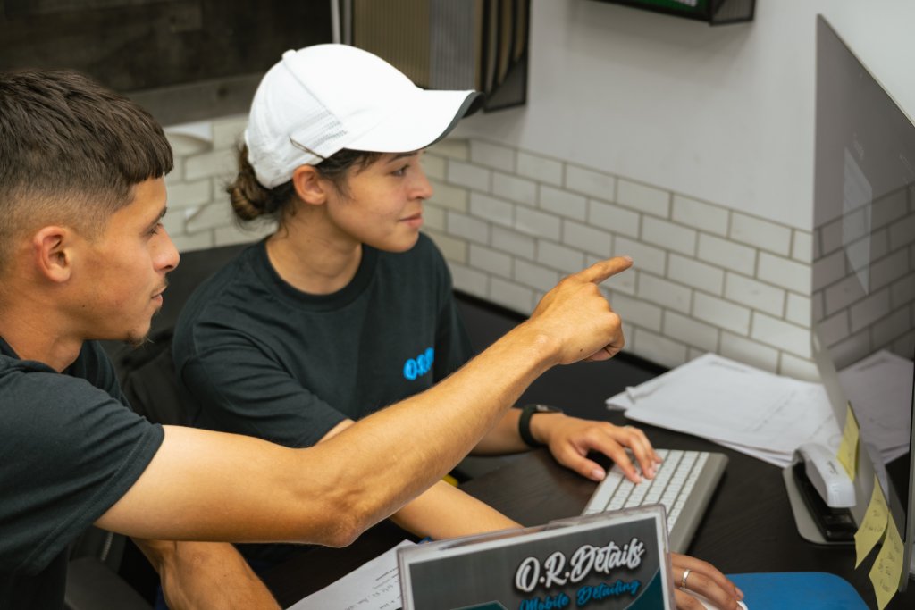 Two team members reviewing bookings at the computer
