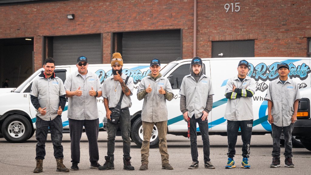 Team of 7 in front of branded van at 915