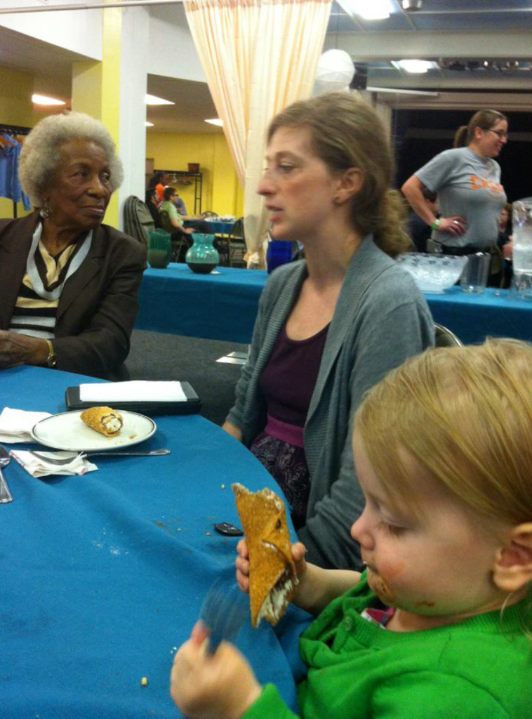 Marlo eating a cannoli with Karen and Mari Evans