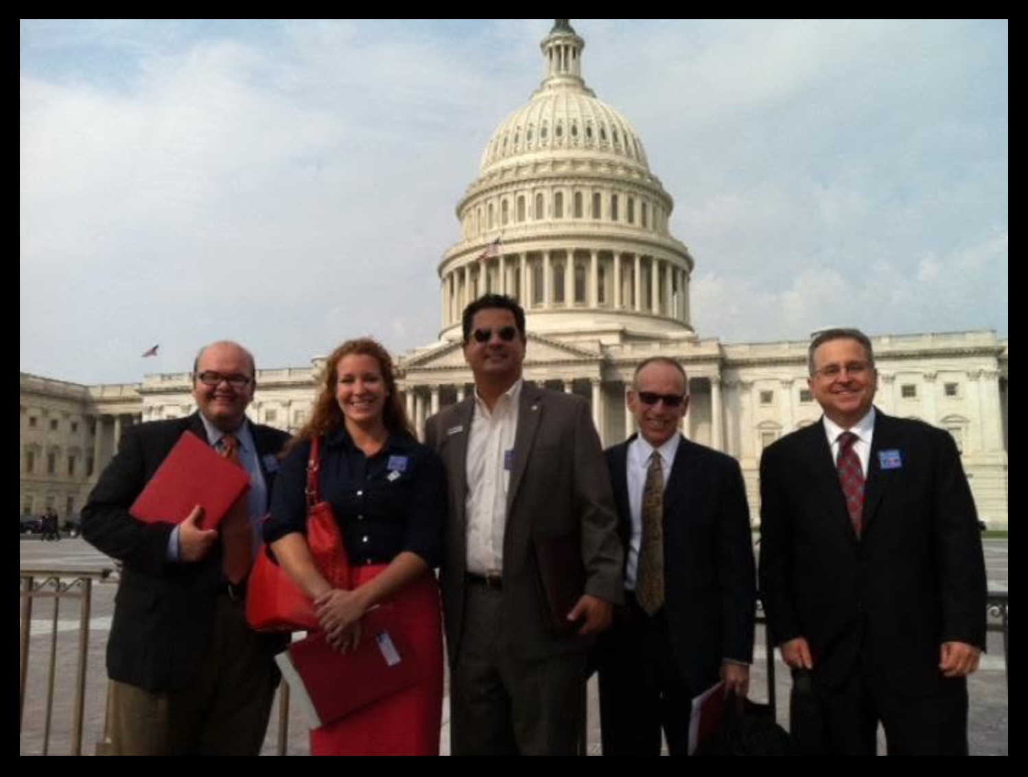 Five state service commission leaders in front of the U.S. Capitol