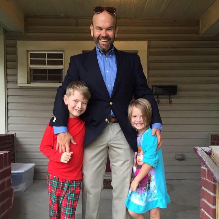 Marc McAleavey with Max and Marlo on the porch of their home