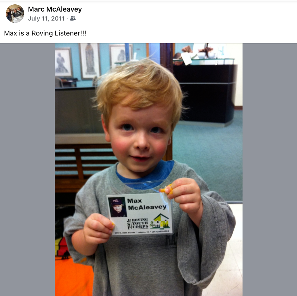 Young Max McAleavey holding his Roving Listener badge
