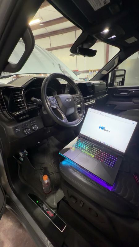 HP Tuners laptop connected inside a Chevrolet truck