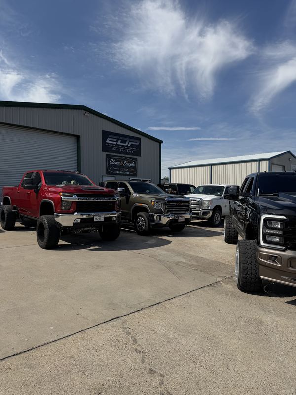 Lifted diesel trucks parked outside the Express Diesel Performance shop