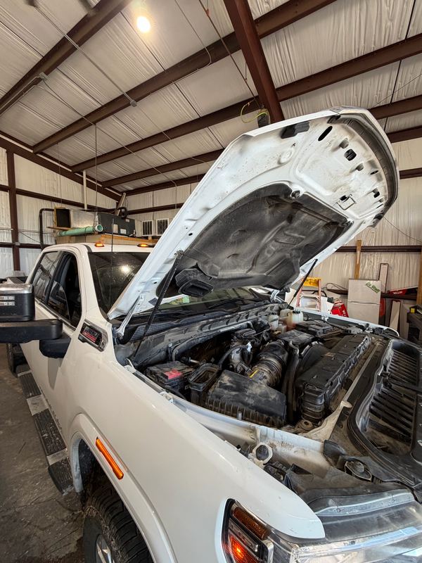 White Chevrolet 2500 Duramax in the shop bay