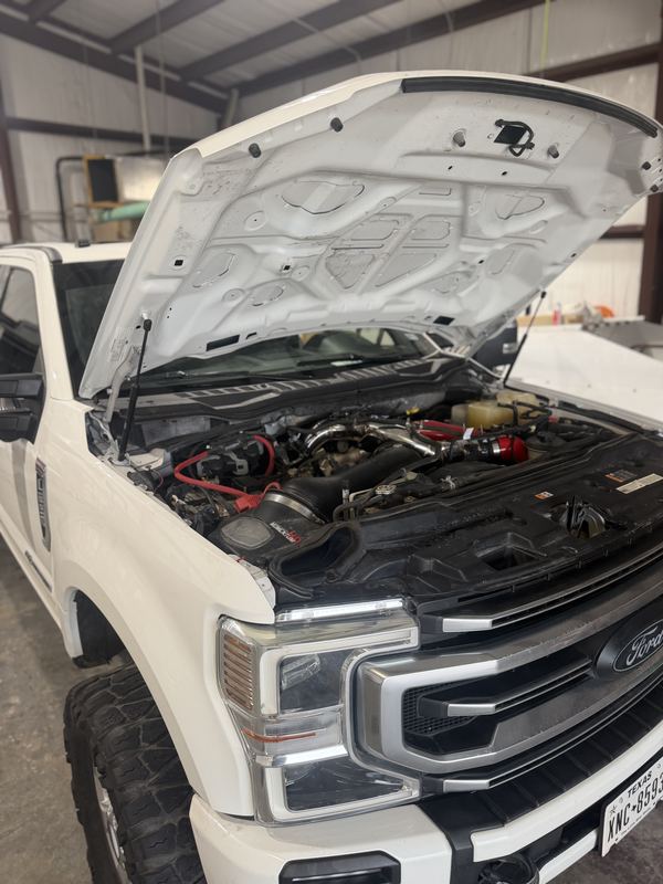 White Ford Super Duty Power Stroke with the hood up