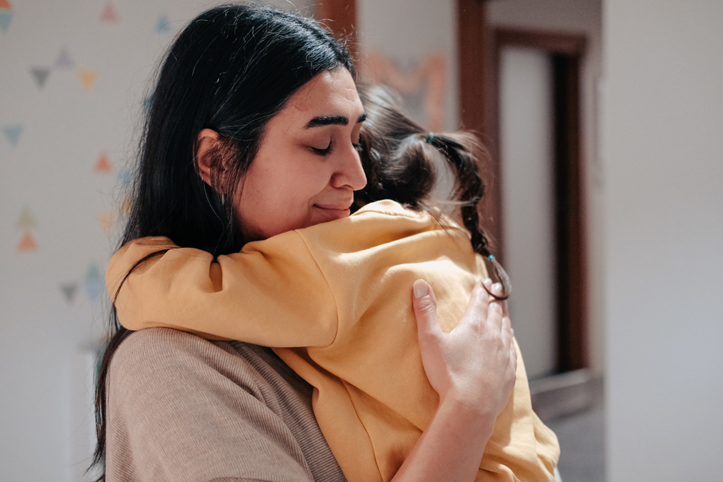 Parent embracing child
