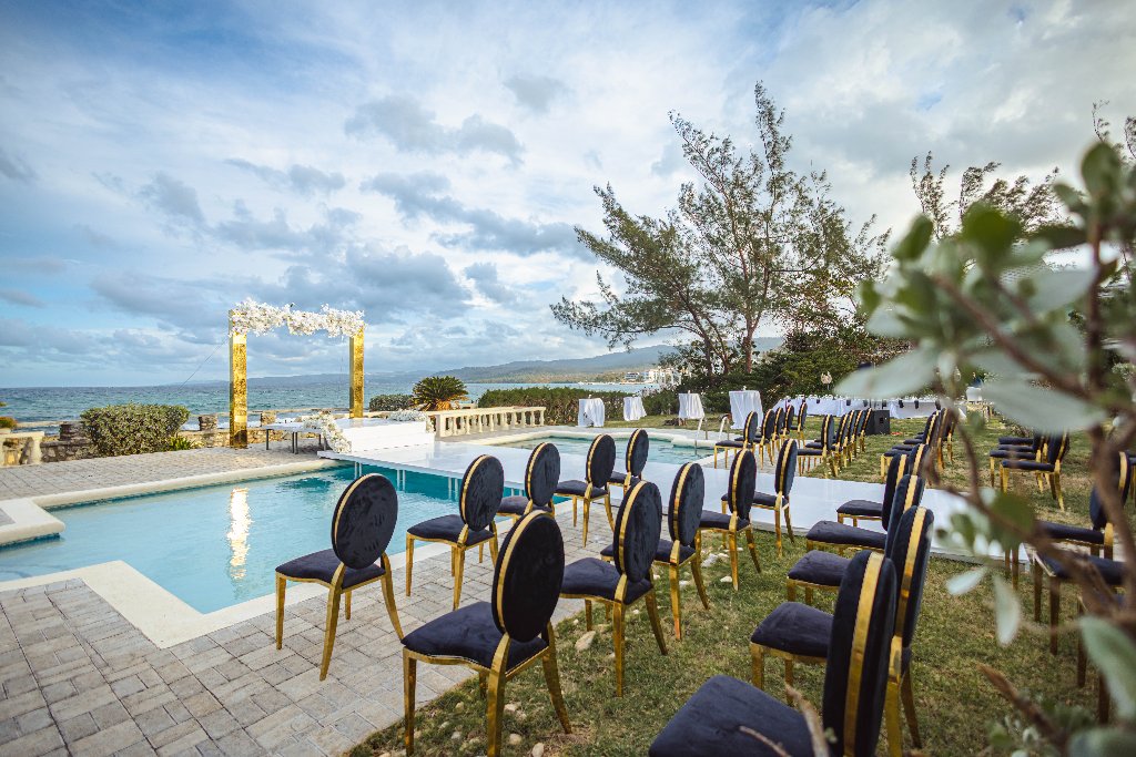 Outdoor ceremony space with pool and ocean backdrop
