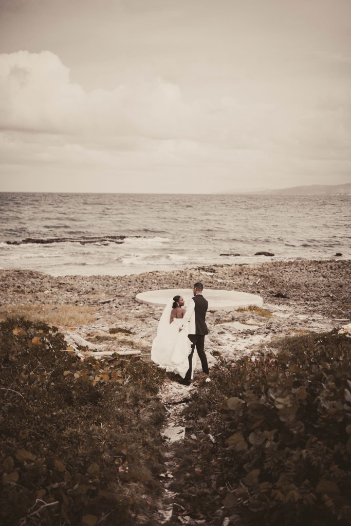 Couple at beachfront with dramatic coastal scenery