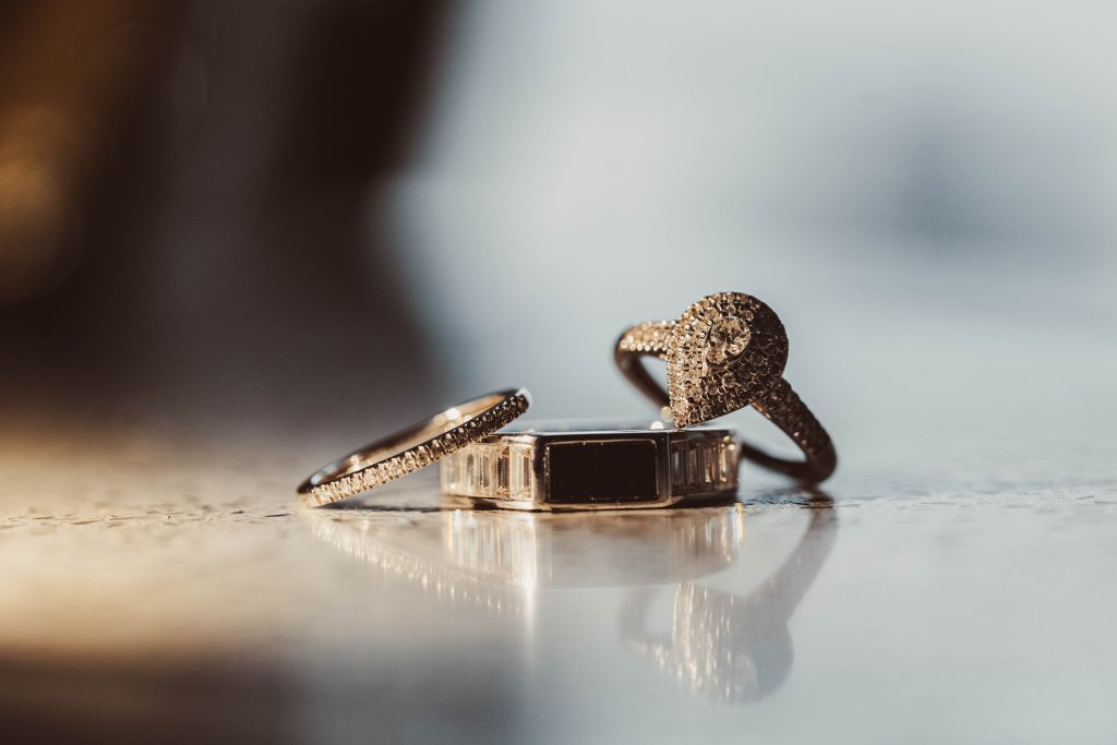 Wedding details flat lay with white heels and invitation