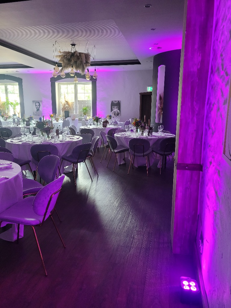 Eleganter Festsaal mit lilaner Ambientebeleuchtung