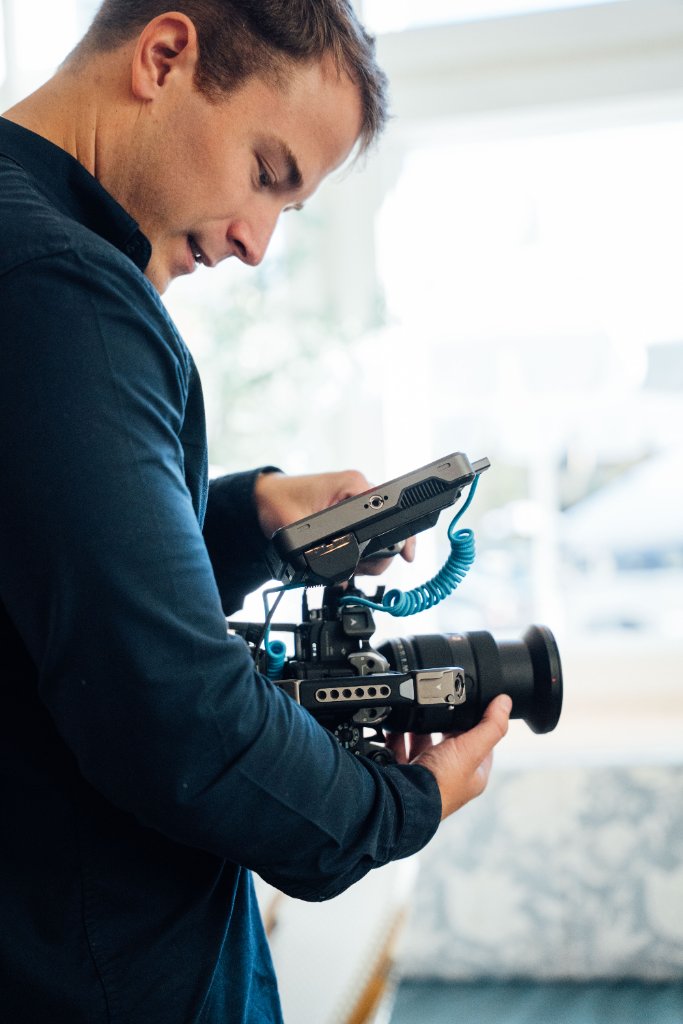 McCoy Visuals filmmaker operating cinema camera on location for a Gulf Coast brand