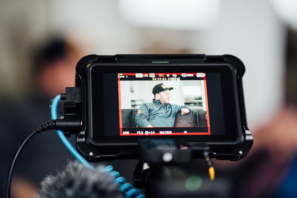 McCoy Visuals cinematographer adjusting camera settings during a brand video production shoot