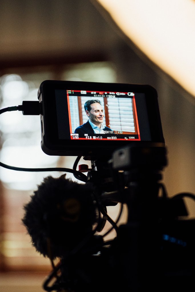 McCoy Visuals cinematographer adjusting camera settings during a brand video production shoot