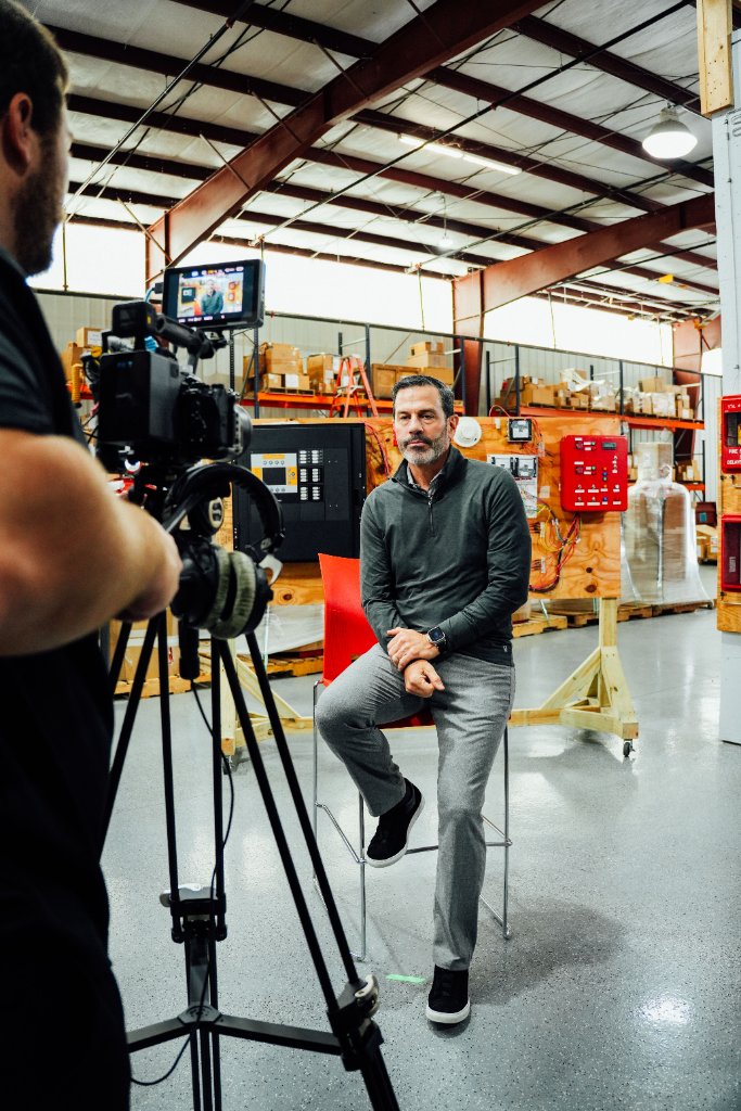 McCoy Visuals camera operator framing a cinematic shot during a commercial production