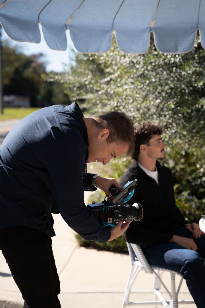 McCoy Visuals director of photography reviewing shot composition on commercial film set