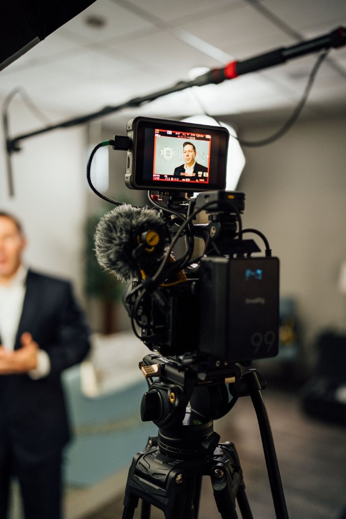 McCoy Visuals cinematographer adjusting camera settings during a brand video production shoot